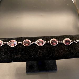 Sterling bracelet with purple crystals.